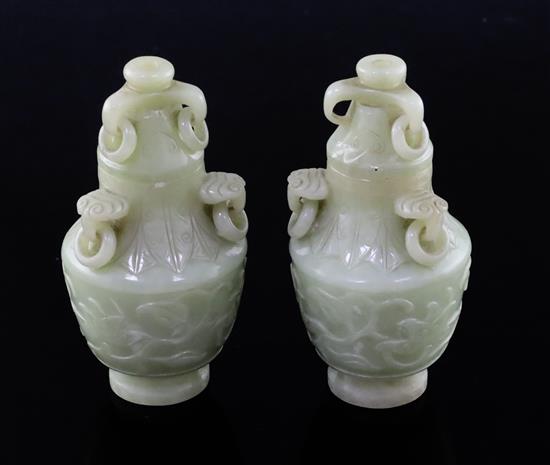 A pair of Chinese carved jade vases and covers, height 12cm